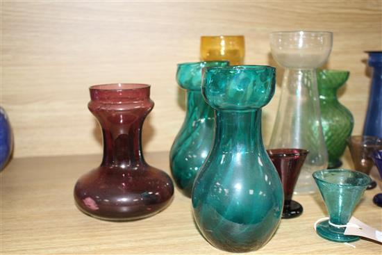 Seven Edwardian coloured glass hyacinth vases, a slender specimen vase and a thirteen other assorted glasses